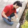 Mark Powers installing edging blocks with a rubber mallet