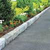 finished driveway edging with flowers and shrubs planted on the side
