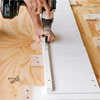 hands attaching the cut ledges for the bottom boards of this all weather planter