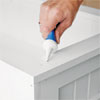 hands using spackling paste to fill the fastener holes of this all weather planter
