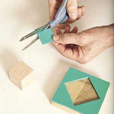 cutting patterns out of craft foam to glue onto scrap wood blocks