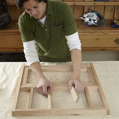 person dry fitting the cut parts together to test the parts for building dog gate