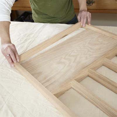 hands attaching the panel for building a dog gate