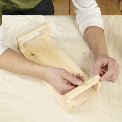 hands working with wood and glue