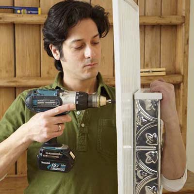man drilling box to board