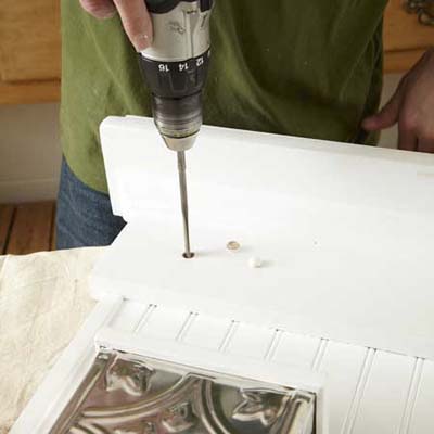 hands drilling wall organizer