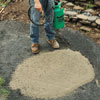 Mark Powers dampening the dry concrete mix with a garden sprayer