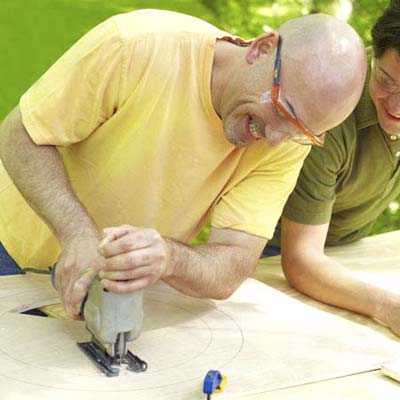 two men cutting out rings to make shishkaball game