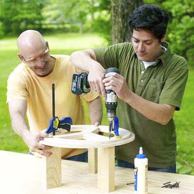 two men attaching legs to make shishkaball game