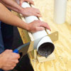 man cutting angle from pipe 