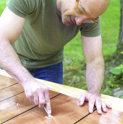 people applying the point graphics while building a ricochet game board