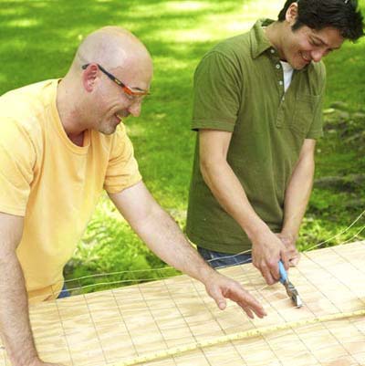 two men cutting wire to make shishkaball game