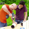 Man drilling holes into a pipe 