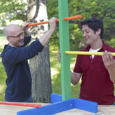 two men inserting rungs for ladder golf game set