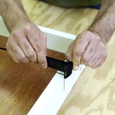people inserting the elastic while building a ricochet game board