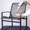 man slashing old mesh chair sling
