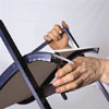 man trimming the rods of outdoor patio chair with replaced mesh sling