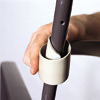 man wrapping vinyl strap around outdoor patio chair frame