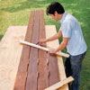 Mark Powers uses a piece of the template to measure out the pieces of deck to cut for the bench seats