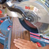 Mark Powers cuts the decking boards for the bench seats with a compound miter saw