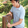 Mark Powers tightens the bolts on the tree bench leg pieces