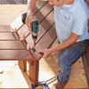 Mark Powers fastens the deck seating to the leg pieces