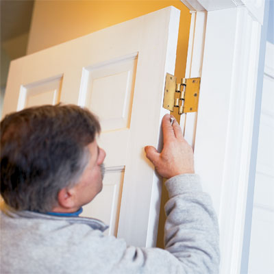 this old house general contractor tom silva re-hanging the repaired door