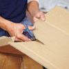 man cutting out cardboard template for wall niche installation