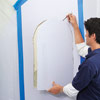 man removing wall cut out for wall niche installation