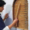 man installing additional padding for wall niche installation