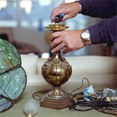 hands rewiring a lamp
