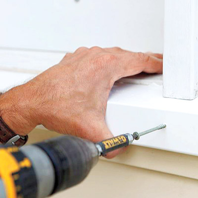 man attaching new windowsill