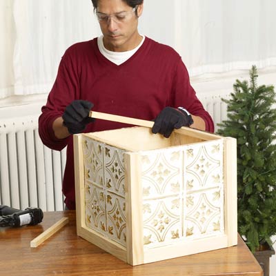 Mark Powers adds interior support strips of the x-mas tree box stand