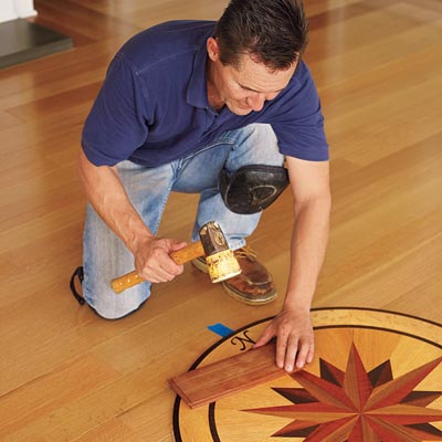 tapping the medallion flush with the rest of the floor with a rubber mallet and a piece of scrap wood to prevent scratches