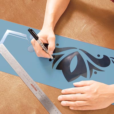 Mark Powers traces the stencil pattern onto stencil film