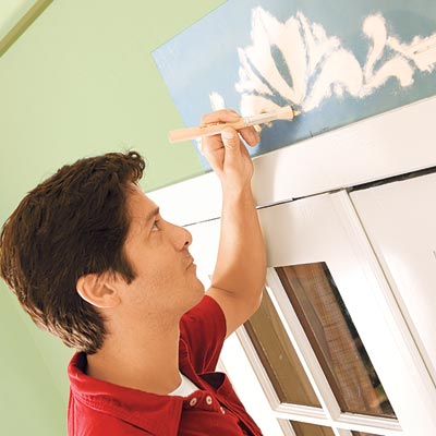 Mark Powers stipples paint into the stencil pattern