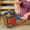 thread the cord and ground wire through the chain to rewire an all-weather lantern