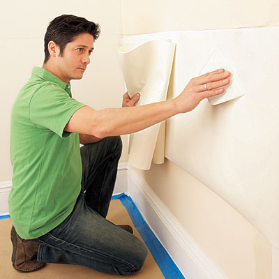 using a smoother to affix the liner to the wall before applying the wainscot