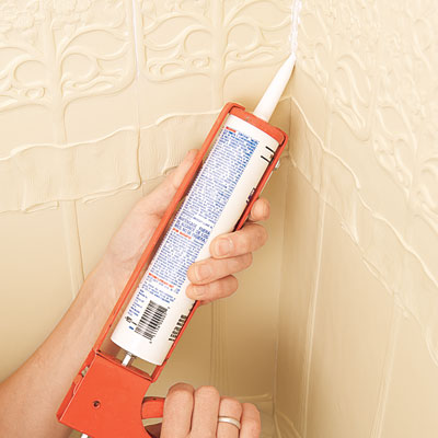 applying caulk to the corner of the installed Lincrusta wainscot panels
