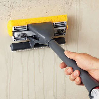 washing the wall with a sponge mop