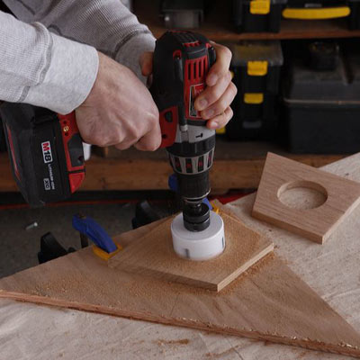 man installing coaster blocks on poker table