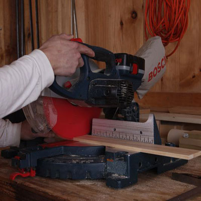 cutting a glass rack piece with a miter saw