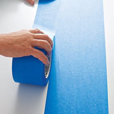laying the third row of painter's tape on a table surface