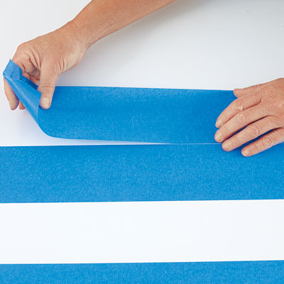 completing the first row of stripes with painter's tape as spacer