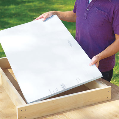 Mark Powers cuts foam for hypertufa table insulation with a utility knife