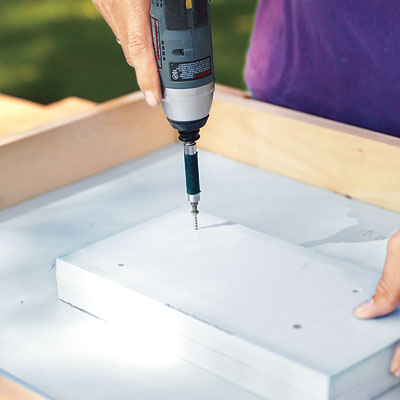 Mark Powers fastens a foam piece for the recessed area of a hypertufa table