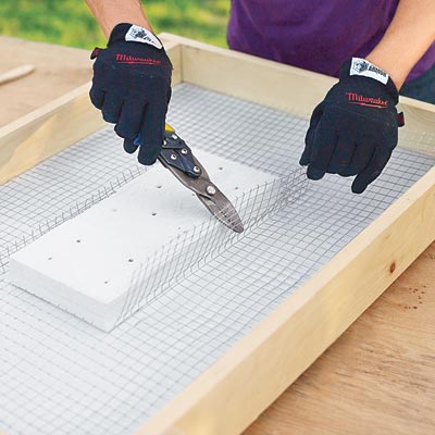 Mark Powers cuts wire mesh for the recessed area of a hypertufa table