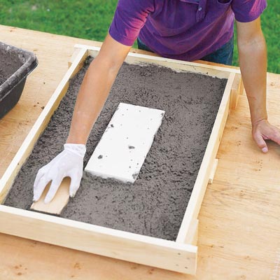 Mark Powers fills the table frame with the hypertufa mix