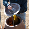 attaching the compost bag to the lid of a rain barrel