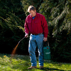Roger Cook spraying compost tea to fertilize a lawn